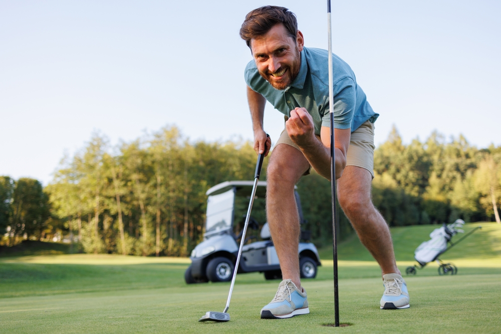 Celebratory,Moment:,Golfer,Retrieves,Final,Putt
